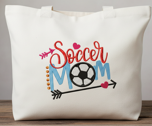 White tote bag with 'Soccer Mom' text and graphics embroidered 
