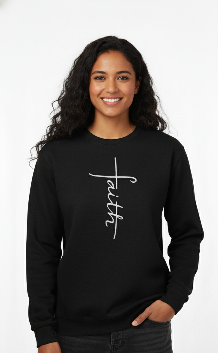 Woman wearing a black sweatshirt with 'faith' embroidered on it against a white background