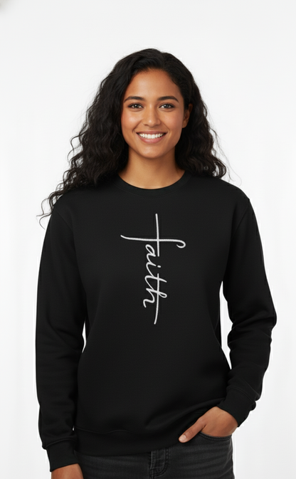 Woman wearing a black sweatshirt with 'faith' embroidered on it against a white background